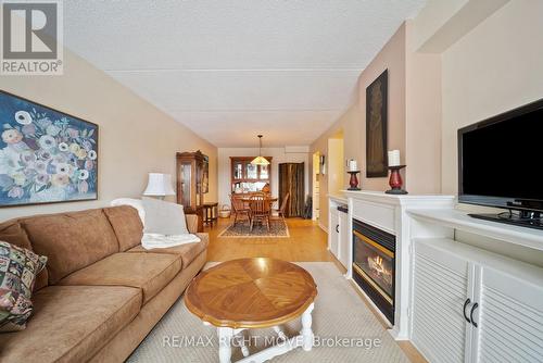 204 - 54 Fittons Road W, Orillia, ON - Indoor Photo Showing Living Room With Fireplace