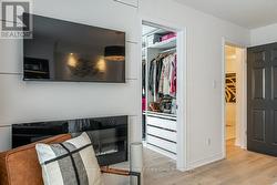 Primary Bedroom w Electric Fireplace + Walk-In - 