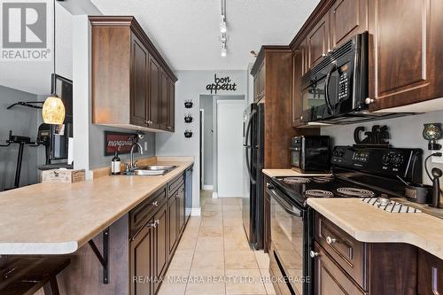 205 - 6390 Huggins Street, Niagara Falls (Stamford), ON - Indoor Photo Showing Kitchen With Double Sink