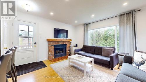 101 - 23 Dawson Drive, Collingwood, ON - Indoor Photo Showing Living Room With Fireplace