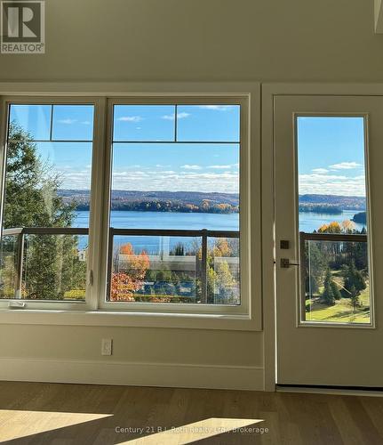 302 - 11 Treetops Lane, Huntsville (Chaffey), ON - Indoor Photo Showing Other Room With Body Of Water