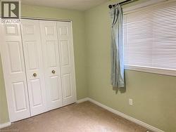 Unfurnished bedroom featuring light colored carpet and a closet - 