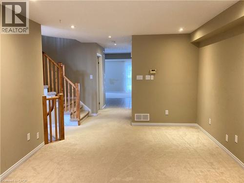 Empty room with light colored carpet, recessed lighting, and stairs - 421 White Birch Avenue, Waterloo, ON - Indoor Photo Showing Other Room