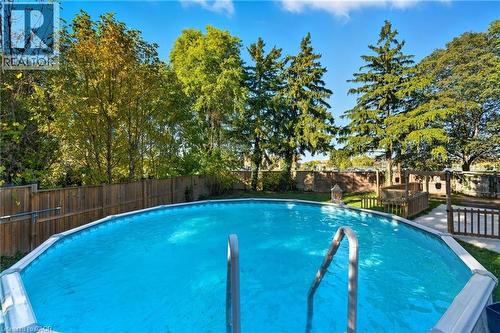 View of swimming pool with a fenced backyard and a patio area - 17 Carmen Avenue, Hamilton, ON - Outdoor With Above Ground Pool With Backyard