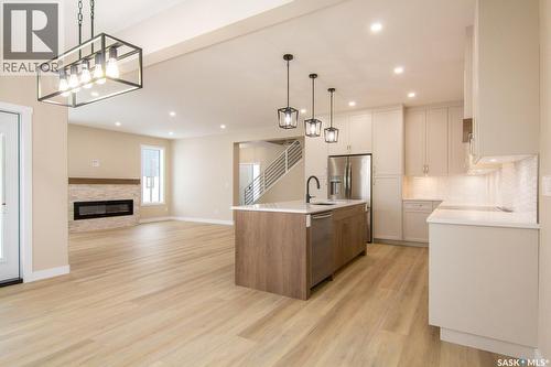 435 Sharma Crescent, Saskatoon, SK - Indoor Photo Showing Kitchen With Fireplace With Upgraded Kitchen