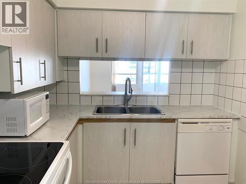 75 Riverside Drive East Unit# 410, Windsor, ON - Indoor Photo Showing Kitchen With Double Sink