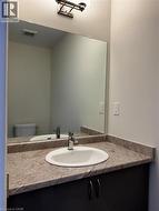Half bathroom with vanity and toilet - 
