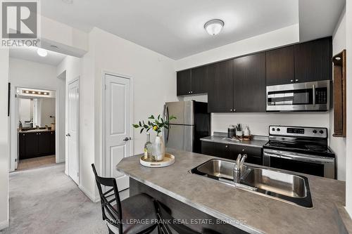 405 - 80 Aspen Springs Drive, Clarington (Bowmanville), ON - Indoor Photo Showing Kitchen With Double Sink