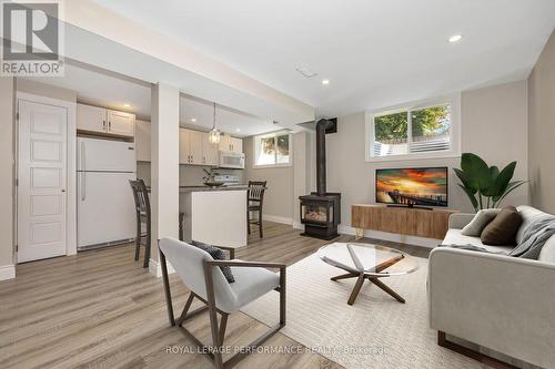 Virtually staged living room - B - 336 Tulip Crescent, Ottawa, ON - Indoor Photo Showing Living Room With Fireplace