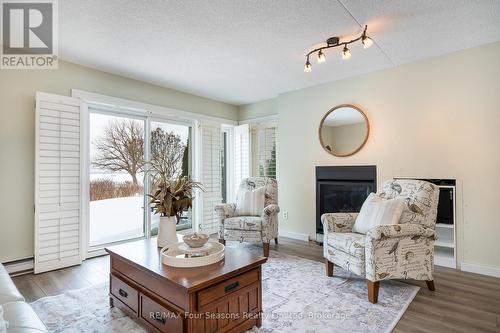 walkout from living room to patio - 25 - 44 Trott Boulevard, Collingwood, ON - Indoor Photo Showing Living Room With Fireplace