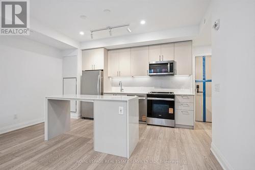 Island Ideal for Everyday Living and Entertaining - 223 - 3250 Carding Mill Trail, Oakville, ON - Indoor Photo Showing Kitchen With Stainless Steel Kitchen With Upgraded Kitchen