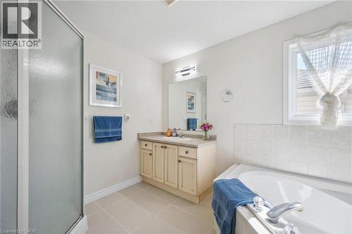 Bathroom with vanity, a bath, light tile patterned floors, and a stall shower - 723 Black Cherry Street, Waterloo, ON - Indoor Photo Showing Bathroom