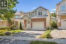 View of front of home with a porch, driveway, an attached garage, roof with shingles, and brick siding - 723 Black Cherry Street, Waterloo, ON  - Outdoor With Facade 