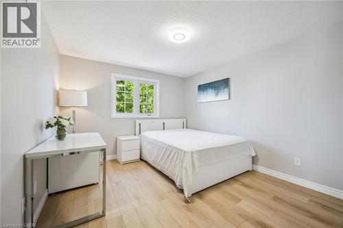 Bedroom featuring light wood-style floors and a textured ceiling - 723 Black Cherry Street, Waterloo, ON - Indoor Photo Showing Bedroom