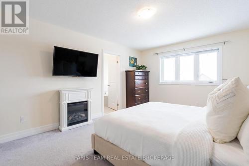 12 Hutton Crescent, Essa, ON - Indoor Photo Showing Bedroom With Fireplace