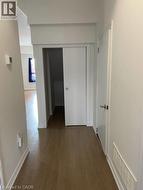 Corridor featuring dark wood finished floors - 