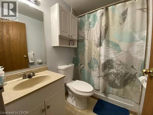 Full bath with vanity, shower / bath combination with curtain, and light tile patterned flooring - 35 Green Valley Drive Unit# 414, Kitchener, ON - Indoor Photo Showing Bathroom