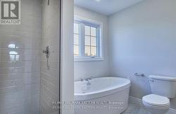 primary bath with tiled shower & soaker tub - 