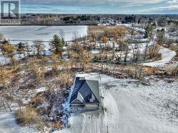 Drone view showing trees and brook in back of hous - 