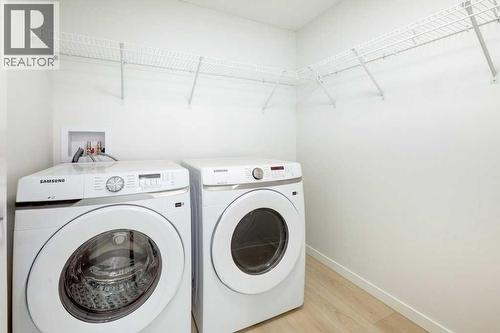 124, 245 Edith Place Nw, Calgary, AB - Indoor Photo Showing Laundry Room