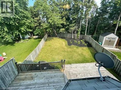 Fenced backyard featuring a storage unit and a deck - 214 Benesfort Crescent, Kitchener, ON - Outdoor With Deck Patio Veranda