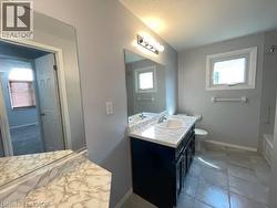 Bathroom with vanity, plenty of natural light, and bathing tub / shower combination - 