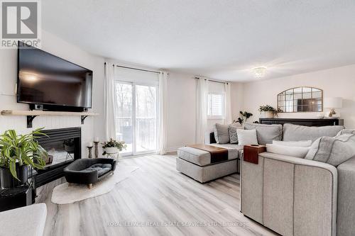 213 - 2110 Cleaver Avenue, Burlington, ON - Indoor Photo Showing Living Room With Fireplace