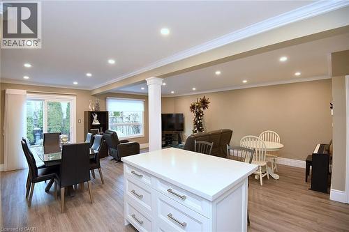 Kitchen with white cabinets, light wood finished floors, open floor plan, ornamental molding, and recessed lighting - 1245 Stephenson Drive Unit# 20, Burlington, ON 