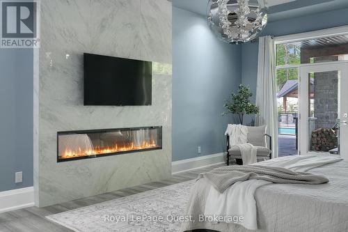 8 Midves Court, Springwater (Midhurst), ON - Indoor Photo Showing Bedroom With Fireplace