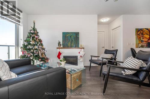 718 - 2550 Simcoe Street N, Oshawa, ON - Indoor Photo Showing Living Room With Fireplace