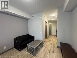 Sitting room featuring a textured ceiling and light wood-type flooring - 
