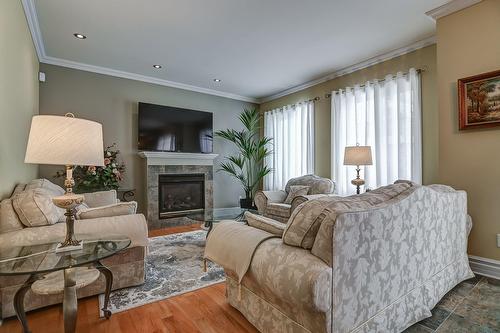 Family room - 7655 Rue Liege, Brossard, QC - Indoor Photo Showing Living Room With Fireplace