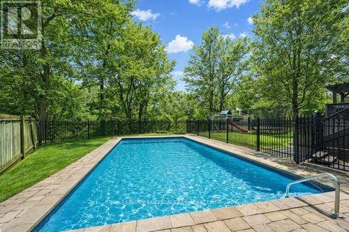 Heated Inground Pool with a Waterfall Feature - 1302 Hillview Crescent, Oakville, ON - Outdoor With In Ground Pool With Backyard