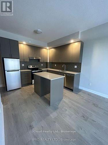 1706 - 3220 William Coltson Ave. Avenue, Oakville, ON - Indoor Photo Showing Kitchen With Stainless Steel Kitchen