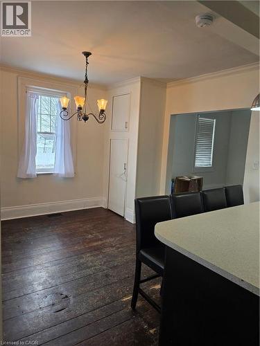 Dining area featuring dark wood-style flooring, crown molding, and a chandelier - 10 Centre Street, Elmira, ON - Indoor Photo Showing Other Room