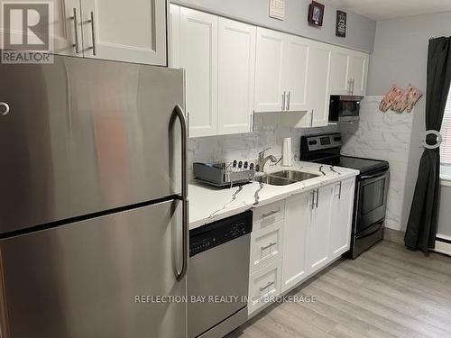 Beautifully renovated Kitchen with white cabinets - 3 - 5 Applewood Avenue, Hamilton (Stoney Creek), ON - Indoor Photo Showing Kitchen With Stainless Steel Kitchen With Double Sink