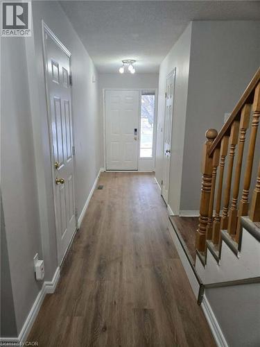 Entryway with stairway, wood finished floors, and a textured ceiling - 185 Sulmona Drive, Hamilton, ON - Indoor Photo Showing Other Room