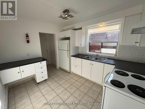 Eat in kitchen with plenty of cabinet space - Main - 468 Ridelle Avenue, Toronto, ON - Indoor Photo Showing Kitchen With Double Sink