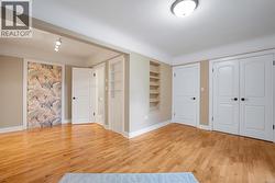 Primary bedroom with oak hardwood floors and attached bathroom - 