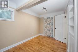 Primary bedroom with oak hardwood floors and attached bathroom - 