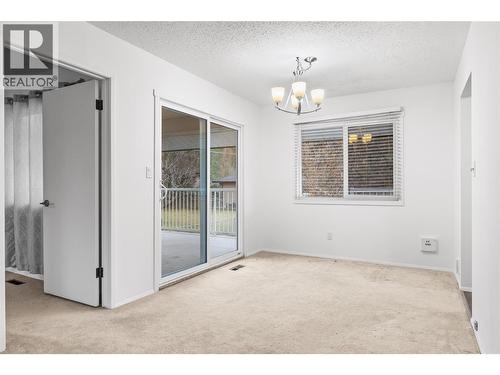 dining room with sliding doors to patio - 811 Tamarack Drive, Kelowna, BC - Indoor Photo Showing Other Room