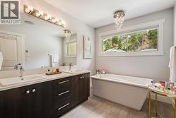 Double vanity sinks, soaker tub & a large walk in glass shower - 