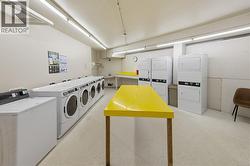 Clean well maintained laundry area with phone tap on machines - 