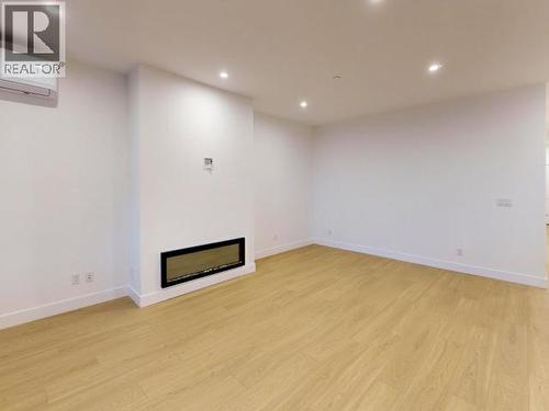 C303-6900 Burnaby Street, Powell River, BC - Indoor Photo Showing Other Room With Fireplace