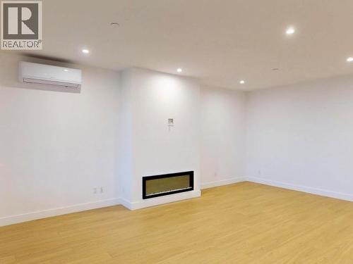 C202-6900 Burnaby Street, Powell River, BC - Indoor Photo Showing Other Room With Fireplace