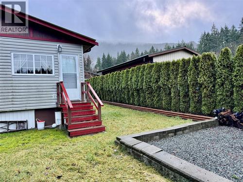Back door off of the addition. Private backyard with fire pit and Gazeboo - 19 8631 South Shore Rd, Lake Cowichan, BC 