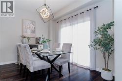 Dining room with baseboards and dark wood finished floors - 