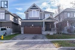 View of front of home with asphalt driveway, a garage, and brick siding - 
