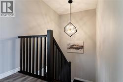 Stairway featuring wood finished floors and baseboards - 