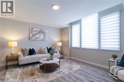 Living room with a textured ceiling and light wood-style flooring - 